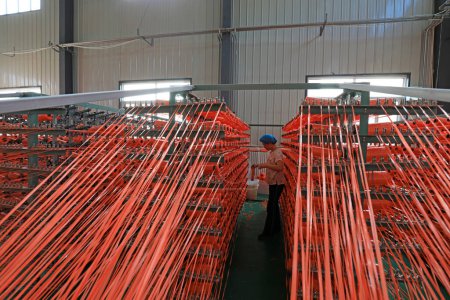 Photo for LUANNAN COUNTY, Hebei Province, China - September 27, 2020: workers are busy on fiber textile production lines - Royalty Free Image