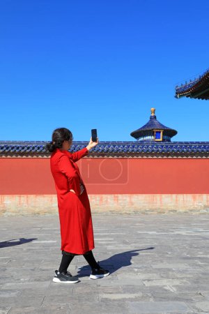 Photo for Beijing, China - October 5, 2020: Female tourists play in the classical architecture of the temple of heaven in Beijing - Royalty Free Image