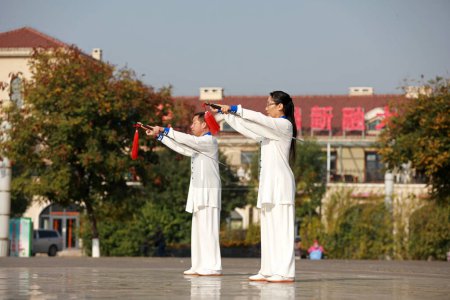Photo for LUANNAN COUNTY, Hebei Province, China - October 18, 2020: People practice Taiji sword in the park - Royalty Free Image