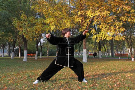 Photo for LUANNAN COUNTY, Hebei Province, China - October 18, 2020: People practice Taijiquan in the woods - Royalty Free Image