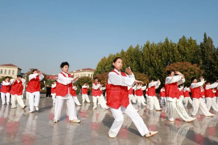 Photo for LUANNAN COUNTY, Hebei Province, China - October 18, 2020: People are practicing Taijiquan in the square - Royalty Free Image