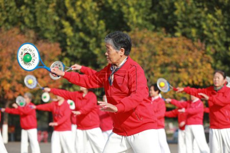 Photo for LUANNAN COUNTY, Hebei Province, China - October 18, 2020: Ladies are practicing Tai Chi softball in the square - Royalty Free Image