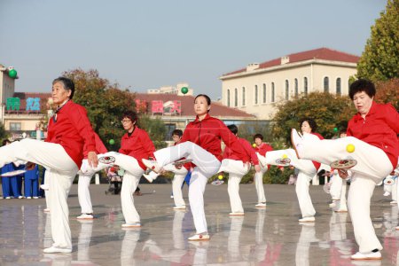 Photo for LUANNAN COUNTY, Hebei Province, China - October 18, 2020: Ladies are practicing Tai Chi softball in the square - Royalty Free Image