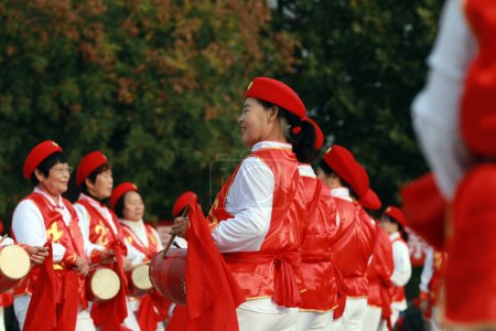 Photo for LUANNAN COUNTY, China - October 25, 2020: Elderly fitness waist drum shows celebrate the Double Ninth Festival in a park square, LUANNAN COUNTY, Hebei Province, China - Royalty Free Image
