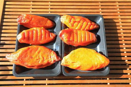 Photo for Baked sweet potatoes in a plastic tray in a restaurant, China - Royalty Free Image