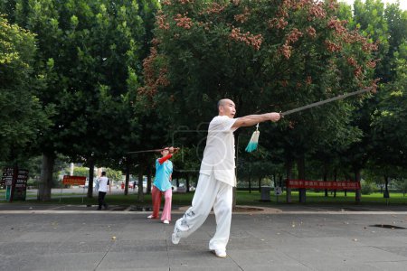 Photo for LUANNAN COUNTY, Hebei Province, China - August 2, 2020: People are practicing Taiji sword in the park - Royalty Free Image