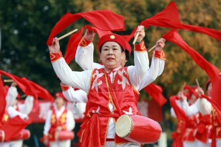 LUANNAN COUNTY, China - October 25, 2020: Elderly fitness waist drum shows celebrate the Double Ninth Festival in a park square, LUANNAN COUNTY, Hebei Province, China