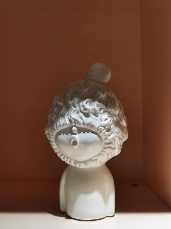 A doll shaped ornament with a hat