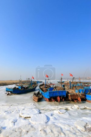 Barcos pesqueros de madera en el hielo