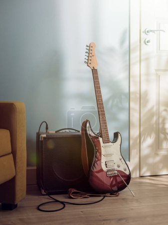 Photo for Electric guitar and amplifier standing on the floor between sofa and door in sunlight from the window - Royalty Free Image
