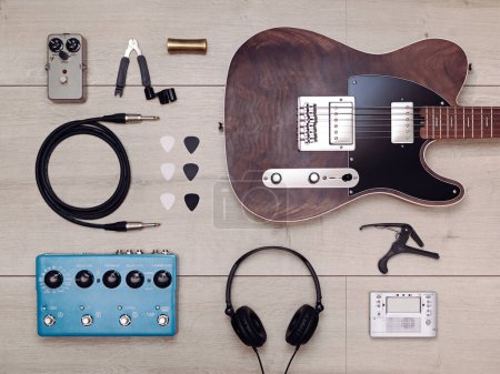 Photo for Flat lay with electric guitar and accessories on the light wooden floor - Royalty Free Image