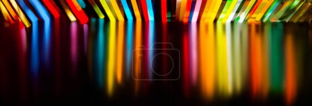 Photo for Light through Stack of different colours Cast Acrylic Sheet on black background - Royalty Free Image