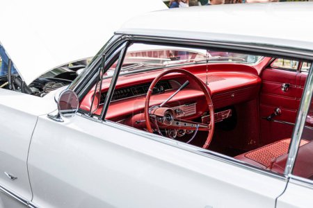 Photo for Babylon, New York, USA - 1 June 2019: Looking through the drivers side window at the red interior of a classic chevy impala at a car show. - Royalty Free Image