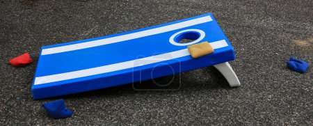 Photo for Blue and white cornhole game on a tar street - Royalty Free Image