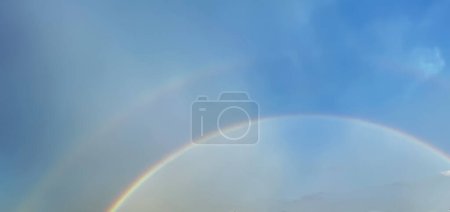 Foto de La naturaleza desvela su resplandor radiante como un encantador arco iris doble que agrada los cielos, cautivando los sentidos de los espectadores. - Imagen libre de derechos