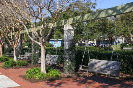 Beaufort, South Carolina, USA - 19 of February 2024: A few wood bench swings hanging in Henry Chambers Park for a great spot to relax in a beautiful park.