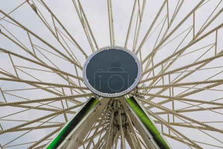 A large ferris wheel rotates against the sky, showcasing the iconic symbol of the fairgrounds.