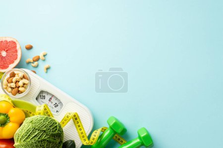 Photo for Detox concept. Top view photo of scales dumbbells vegetables fruits grapefruit bell pepper nuts almonds cashew and tape measure on isolated pastel blue background with copyspace - Royalty Free Image