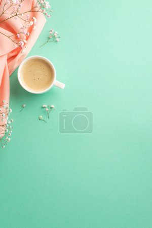 Foto de Hello spring concept. Top view vertical photo of cup of coffee gypsophila flowers and pink plaid on isolated teal background with copyspace - Imagen libre de derechos