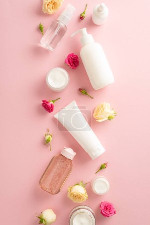 Photo for Discover the beauty of nature with this tender skincare concept. Top view flat lay of pump bottle, pipette, and cream bottles on a pastel pink background - Royalty Free Image