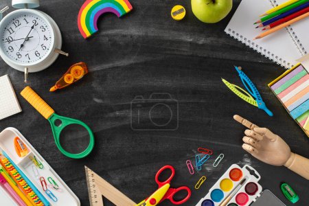 Immerse in creative ambiance of the lecture hall through this top-down perspective: blackboard adorned with assortment of stationery on isolated background, providing copyspace for ad or text