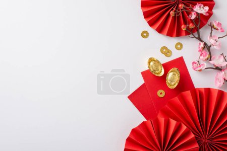 Photo for Celebrate traditions! Top view of red fans, feng shui symbols, lucky coins, Hong Bao, and sakura on a white background. Perfect for messages or advertisements - Royalty Free Image