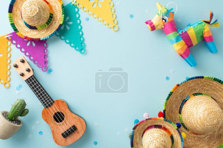 Cinco de Mayo display captured from top view, highlighting traditional pieces such as sombreros, a vihuela, cacti, pinata, flag chains, confetti on a serene blue ground, space for text