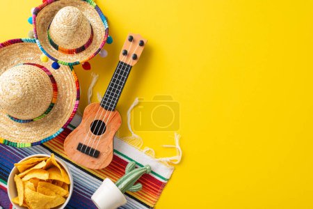 Cinco de Mayo display. View from top capturing essential symbols: compact sombreros, a folk vihuela, cactus in a flowerpot, a lively serape, and a serving of nachos, on a mustard yellow base