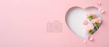 Mother's Day bliss theme. Top-view shot displaying fresh carnations, loving notes, and trendy confetti, framed by a silhouette of a heart on soft pastel pink background, offering space for adverts