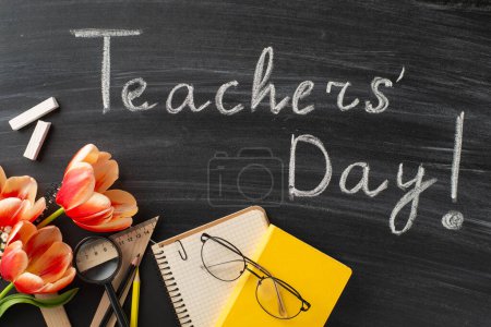 Photo for Express appreciation to your teacher on Teacher's Day with this layout. Top-down view of teaching tools, tulips bunch, and chalked message "Teachers' Day!" on blackboard - Royalty Free Image