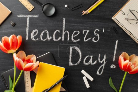 Photo for Show gratitude to your educator on Teacher's Day with this setup. Top view shot of teacher's items, tulips, and blackboard with chalked greeting "Happy Teachers' Day!" - Royalty Free Image
