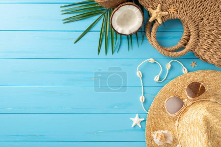 Photo for A vibrant display of summer beach essentials on a blue wooden background, featuring a straw hat, sunglasses, shells, and tropical palm leaves, evoking a feeling of holiday and relaxation - Royalty Free Image