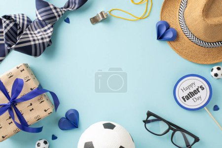 Create bespoke Father's Day wish with top view arrangement featuring straw hat, tie, soccer balls for football fan, referee whistle, giftbox, hearts and more on pastel blue background with empty space