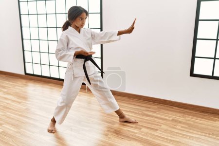 Photo for African american girl wearing kimono training karate at sport center - Royalty Free Image