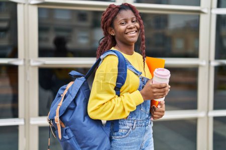 Téléchargez les photos : African american woman student smiling confident drinking coffee at university - en image libre de droit