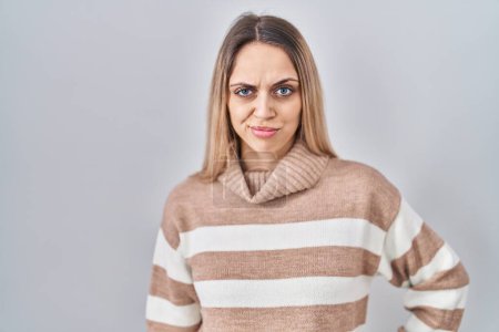 Photo for Young blonde woman wearing turtleneck sweater over isolated background skeptic and nervous, frowning upset because of problem. negative person. - Royalty Free Image