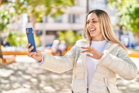 Photo for Young woman smiling confident having video call at park - Royalty Free Image