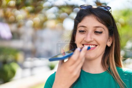 Photo for Young hispanic woman smiling confident talking on the smartphone at park - Royalty Free Image