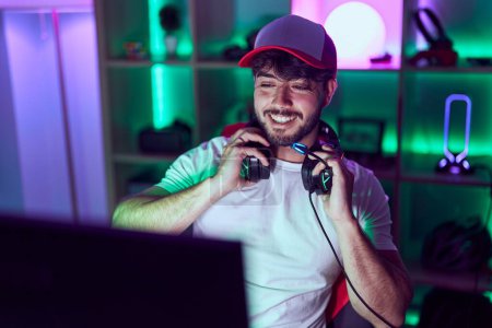 Photo for Young hispanic man streamer smiling confident using computer at gamin room - Royalty Free Image
