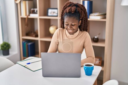 Photo for African american woman student using laptop studying at home - Royalty Free Image