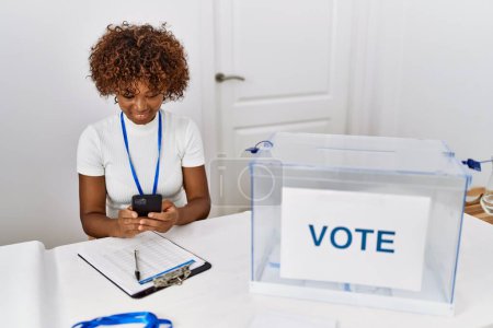 Photo for Young african american woman smiling confident using smartphone at electoral college - Royalty Free Image