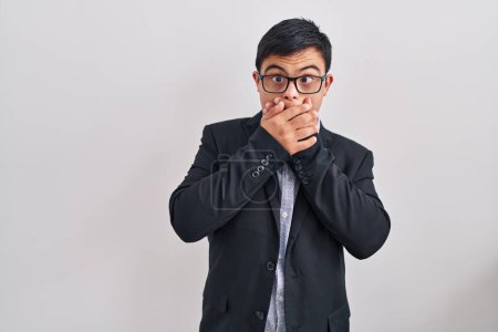 Photo for Young hispanic man with down syndrome wearing business style shocked covering mouth with hands for mistake. secret concept. - Royalty Free Image