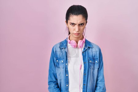 Téléchargez les photos : Young beautiful woman standing over pink background skeptic and nervous, frowning upset because of problem. negative person. - en image libre de droit