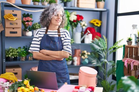 Photo for Middle age grey-haired woman florist smiling confident standing with arms crossed gesture at florist - Royalty Free Image