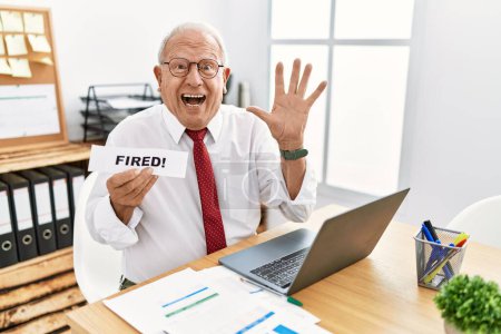 Photo for Senior business man holding fired banner at the office celebrating victory with happy smile and winner expression with raised hands - Royalty Free Image