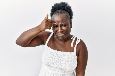 Photo for Young african woman standing over white isolated background pointing unhappy to pimple on forehead, ugly infection of blackhead. acne and skin problem - Royalty Free Image