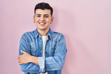 Photo for Non binary person standing over pink background happy face smiling with crossed arms looking at the camera. positive person. - Royalty Free Image