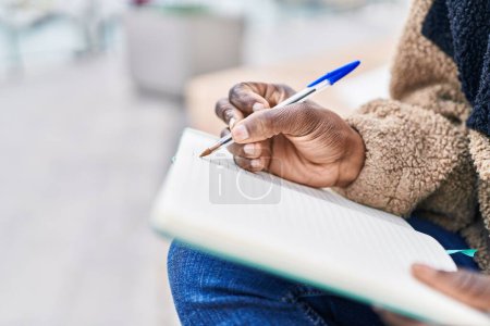 Photo for African american woman writing on notebook at street - Royalty Free Image