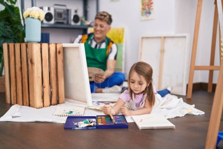 Photo for Father and daughter artists smiling confident drawing at art studio - Royalty Free Image