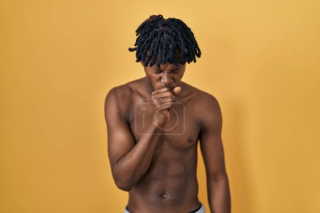 Photo for Young african man with dreadlocks standing shirtless feeling unwell and coughing as symptom for cold or bronchitis. health care concept. - Royalty Free Image